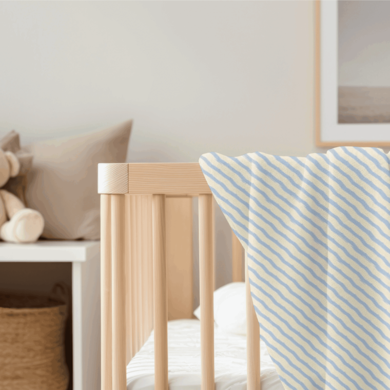 Nursery crib with striped bedding