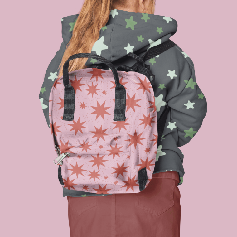 Backpack with red starburst pattern on pink background